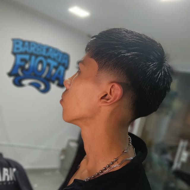 Cliente com corte fade na Barbearia Fjota